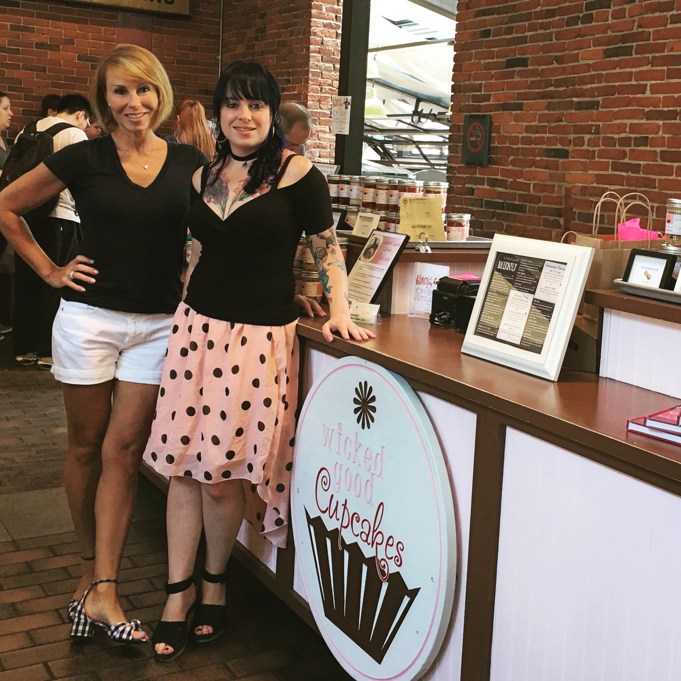 Tracey and Dani standing next to their counter in their first store.